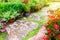 BeautifulÃƒâ€šÃ‚Â garden and stone path and  blooming flower and tree with green leaves